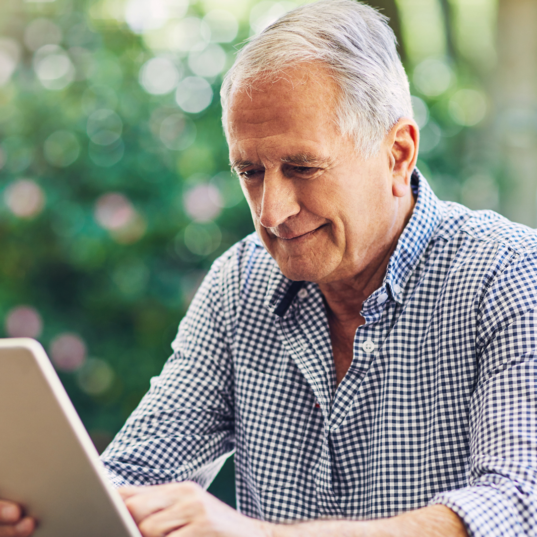 Older man using his tablet